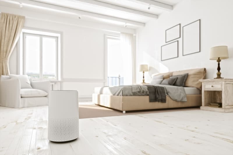 Close-up of an indoor air purifier in a modern bedroom — HEPA filtration at work