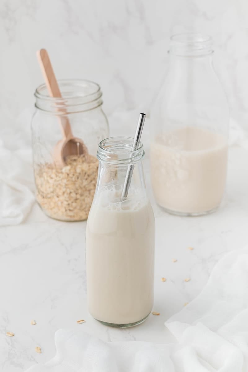 Almond milk and oat milk cartons side by side on a kitchen counter — which is healthier?