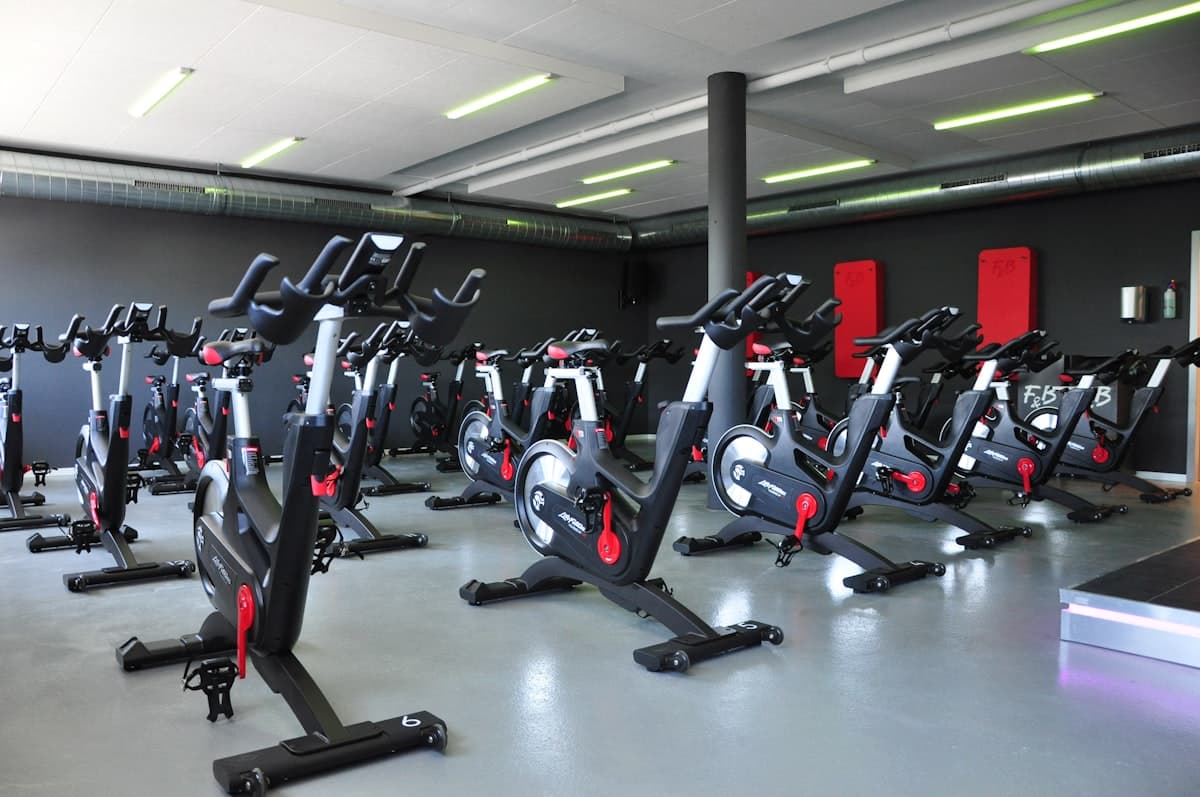 Compact home gym with adjustable dumbbells and kettlebells showing space requirements
