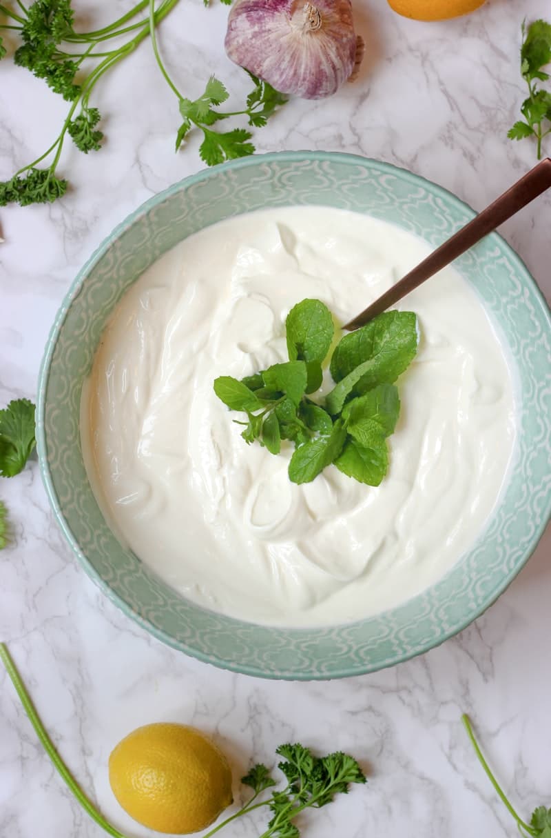 Greek yogurt and regular yogurt bowls side by side with fresh berries — comparing two yogurt types for gut health and bloating