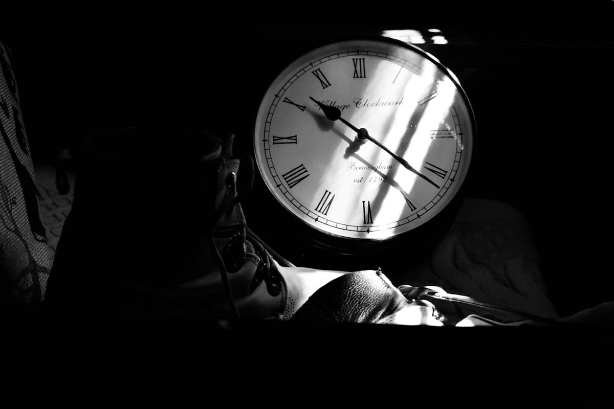 Black and white analog clock face representing the body's 24-hour circadian rhythm that governs the NAD+ cycle