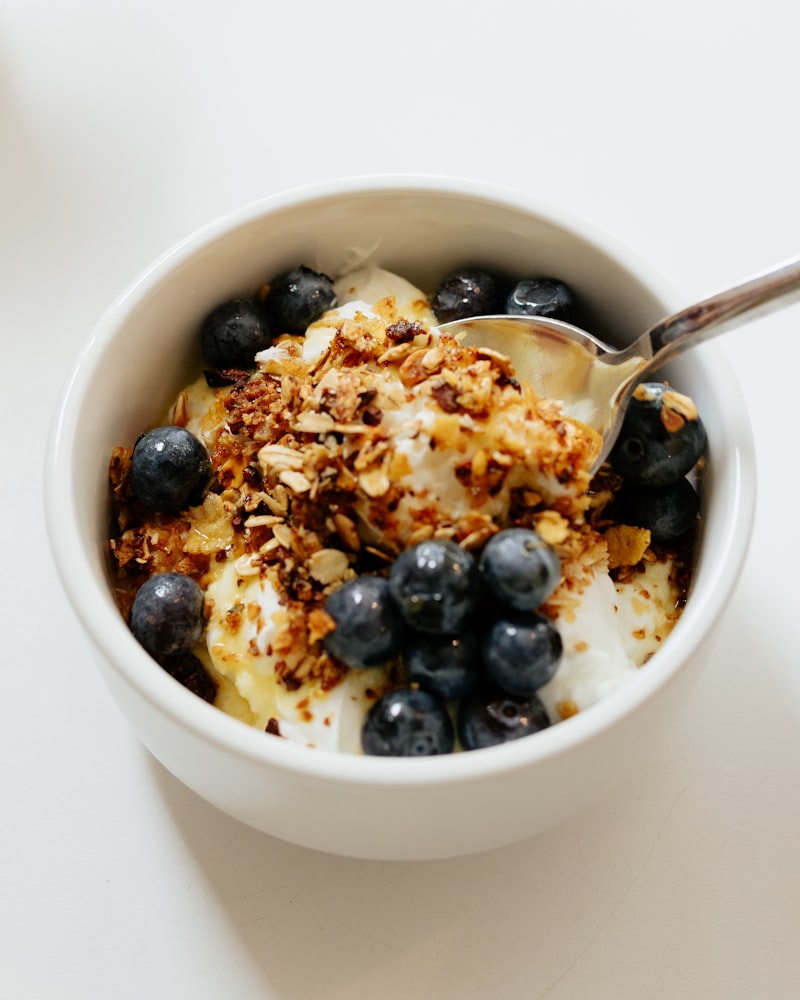 Greek yogurt parfait topped with blueberries and granola — a high protein breakfast idea