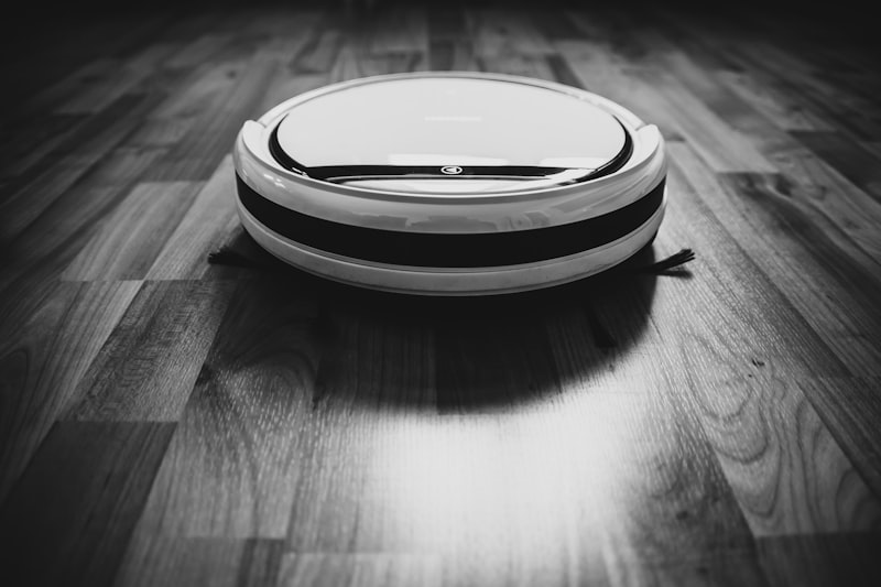 Robot vacuum autonomously cleaning a hardwood floor — LiDAR navigation at work